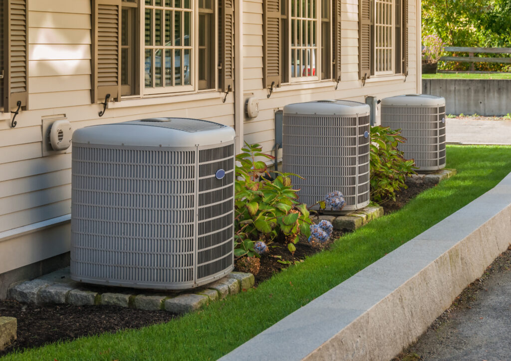 Air conditioning and heating inverters on the side of a house